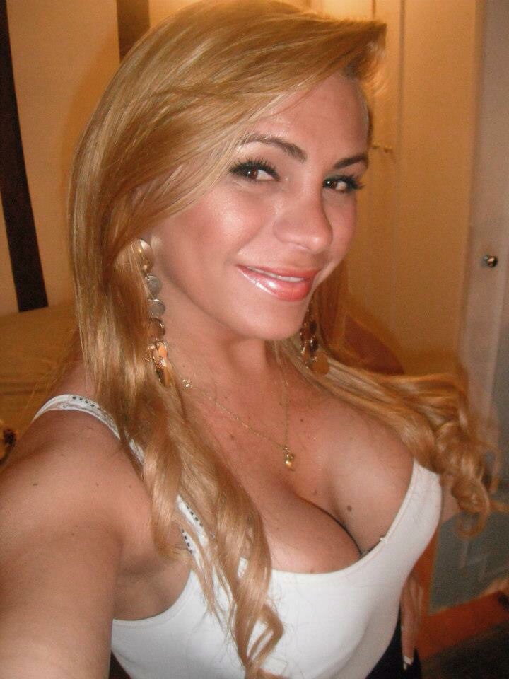 Aria in a white top with gold earrings