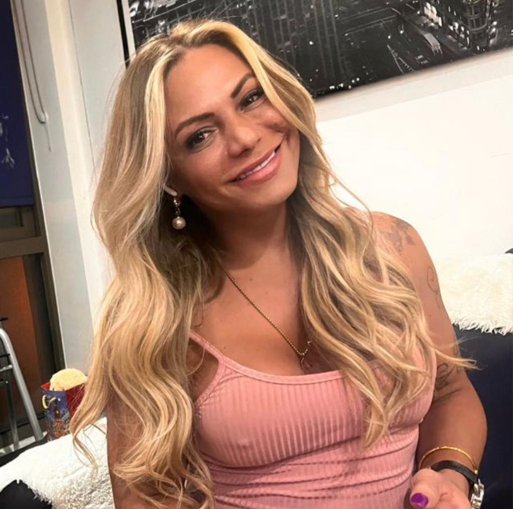 Aria smiling in a pink top