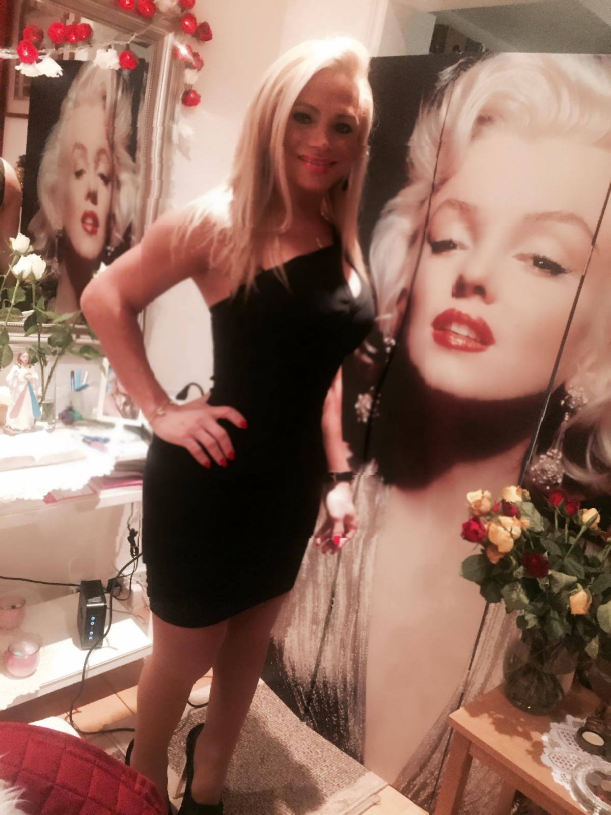 Aria in a black dress at an evening event